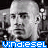 Two side-by-side pixelated grayscale images of a bald man with neutral expression, each overlaid with blue text reading "vindiesel" in blocky font.