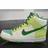 Pixelated image of a white athletic shoe with green accents and a dark green swoosh logo on the side.