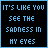 Two side-by-side animated frames of a pixelated text-based buddy icon with blue and white lettering on black backgrounds, showing frame-to-frame color changes in the text.