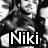 A black-and-white image of a person with dark hair and intense expression, overlaid with text "Niki" in white letters on a black background.