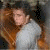 A person with long brown hair in a white shirt appears in four , each showing text variations of 'ronnie day music .com' over the image