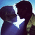 Two silhouetted figures in profile kiss under a bright star against a blue sky, with one figure wearing a yellow garment.