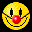 Pixelated yellow smiley face with red nose, black eyes, and green mouth outline on black background.