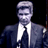 Static pixelated image of a person in formal attire against black background with visible dithering and low-resolution rendering artifacts.