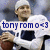 Pixelated image of a person in white chef attire with dark apron, holding brown object, overlaid text 'tony romo 0-3' on light banner.