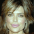 Pixelated static image of a person's face with light brown hair and pink lips against dark background.
