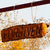 A brown rectangular icon with yellow ends and dark text, set against a light background with faint vertical lines.