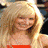 A blonde woman appears in three distinct poses: smiling with arms crossed, holding a bottle while wearing a black dress, and looking down in a pink top.
