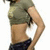 A person in a cropped olive-green t-shirt and dark blue shorts stands with one hand on their hip against a white background.
