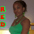 A pixelated image shows a person in a green top with short dark hair, standing beside three red letters on green squares against a gray background.