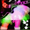 A person in a white tutu plays a guitar with a skull-and-crossbones symbol, shown in multiple color variations and a grayscale version.