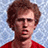 Pixelated image of a person with brown curly hair wearing red shirt against light blue background, next to yellow text on purple background.