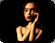Animated sequence of a stylized figure with light brown skin and red hair holding a phone to its ear, showing subtle pose and background light changes.