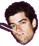 A pixelated headshot of a man with dark curly hair and a white stick-like object in his mouth, set against a light gray background.