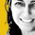 Static pixel art of a stylized face with grayscale tones, black hair, and yellow background on the left side.