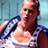 Pixelated static image of a shirtless man with short hair wearing blue and white sports attire against a light blue background.