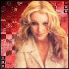 A blonde woman with wavy hair wears a light-colored jacket against a red and pink pixelated background, with small square icons in the corners.