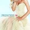 A woman in a strapless white gown with a full skirt, holding her hand near her face, with the word 'PRINCESS' and a pink heart symbol visible.