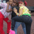 Two pixelated figures embrace; one wears red pants and a white top, the other dark pants with green and yellow accents.
