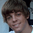 A pixelated image shows a person with brown hair on the left, next to a bright blue background with purple text reading "Courtney's Husband Ryan Sheckler."