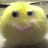 Yellow plush toy with black eyes and pink cheeks in a , displaying text changes
