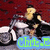 Pixelated image of a person riding a motorcycle with a blue text bubble reading 'Clint E' against a red background.
