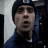 A person wearing a dark beanie and jacket appears in three distinct poses with varying facial expressions against a blurred background.