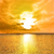 A static pixelated image depicts a bright white sunburst over a calm body of water reflecting the light, set against a warm orange and yellow sky.