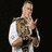 A wrestler appears in multiple poses holding a championship belt, with one frame showing text reading HUSTLE LOYALTY RESPECT.