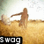Pixelated figure in brown attire stands on sandy ground with arms extended, set against a light sky background, with 'SWAG' text in black and white at bottom left.