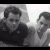 Black-and-white photo of two people in a group pose with green circular symbols overlaid on the right side.