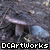 Pixelated image of mushrooms on dark ground with repeated text overlay.