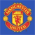 Static pixelated icon featuring a shield-shaped crest with red and gold colors on blue background, surrounded by circular decorative elements.
