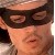 A pixelated close-up of a person wearing a dark headband with a light-colored band, showing partial facial features and a blurred background.
