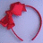 Red headband with bow on light gray background; text overlays appear in different frames.