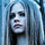Pixelated image of a person with long light blue hair and dark eye makeup on the left, next to white text "AVRIL" on black background on the right.