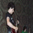 Four distinct show a person in various poses with a red electric guitar, including standing, seated, and embracing another figure against a red backdrop