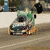 Animated sequence showing a green and silver sprint car on a track with visible text 'WILG' on the vehicle's side.
