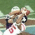 Pixelated image of a football player in mid-action with text overlays reading "THEY BEAT THE PATRIOTS" on white background.