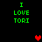 Green text reading 'I LOVE TORI' appears in two vertical on a black background, with red pixelated hearts positioned between and below the