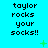 Pixelated text 'taylor rocks your socks!!' repeated across a bright cyan background with scattered green plus and X symbols.