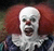 Static pixelated image of a clown with white face paint, red hair, and an open mouth expression against a dark background.
