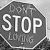 A pixelated octagonal sign with 'STOP' in large white letters and 'LOVE' below it, rendered in grayscale tones.