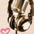 A pixelated image of a person with long brown hair holding a microphone, with a pink heart symbol and the text "music is life" on a pink background.