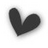 A black heart symbol with a soft blur effect appears on the left side of a white background, accompanied by pixelated text blocks to its right and below.