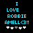 Pixelated cyan text on black background reads "I LOVE ROBBIE AMELL<3!!" with five white and gray heart symbols below.
