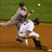 Pixelated baseball scene shows two players on a field with one throwing a ball, next to blue background text reading "Dustin Pedroia 15" in red.
