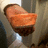 A pixelated close-up of a brown and orange object resembling a slice of meat on a fork against a blurred background.