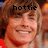 Pixelated close-up of a smiling person with light brown hair, overlaid text 'hottie' in black block letters.