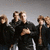 Group of pixelated figures in black hoodies with arms crossed, standing against a gray background beneath partial text reading "OneRepubli".